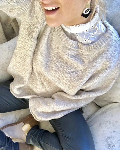 Woman wearing broderie anglaise faux collar from TLM Edit with grey jumper and blue jeans